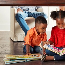 Kids reading book sitting on flooring | Buckway Flooring