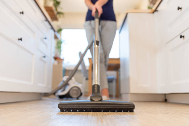 Lady cleaning floor with vacuum cleaner | Buckway Flooring