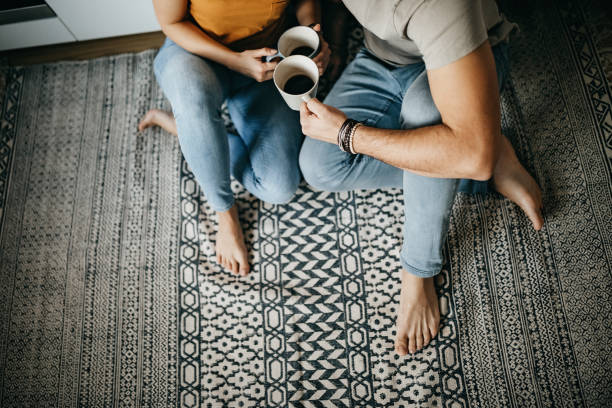 Couple drinking coffee sitting on floor | Buckway Flooring
